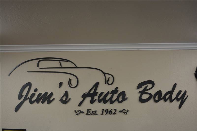 Jim's Auto Body sign inside shop - auto collision center